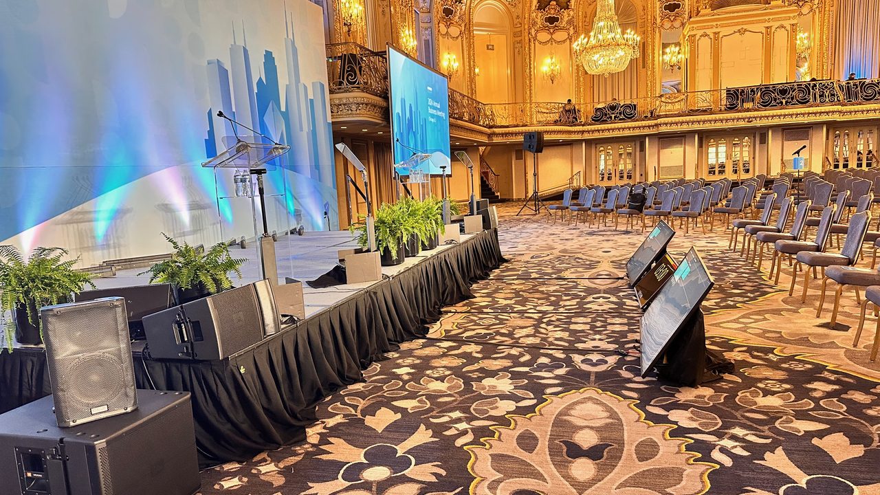 Ornate ballroom pre-show setup with LED wall and PA system